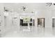 Open-concept living space with high ceilings, white tile floors, and a modern kitchen at 1700 Shandwick Ct, Longwood, FL 32779