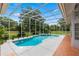 Inviting swimming pool with spa and screened enclosure surrounded by lush landscaping at 1700 Shandwick Ct, Longwood, FL 32779