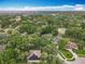 Aerial shot of a lovely neighborhood featuring mature trees, blue skies and a partial view of a lake at 1701 Lucky Pennie Way, Apopka, FL 32712