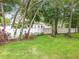 Serene backyard with lush green lawn, white vinyl fencing, and charming garden bench at 1701 Lucky Pennie Way, Apopka, FL 32712
