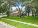 Charming home with mature trees, lush lawn, and a well-maintained exterior for inviting curb appeal at 1701 Lucky Pennie Way, Apopka, FL 32712
