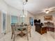 Cozy dining area with a chandelier and sliding glass door that provides access to the patio at 1701 Lucky Pennie Way, Apopka, FL 32712