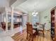 Open concept layout with a dining area featuring a chandelier, hardwood floors and seamless access to the living space at 1701 Lucky Pennie Way, Apopka, FL 32712