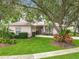 Beautiful home with a manicured lawn, mature trees, and a charming front entrance at 1701 Lucky Pennie Way, Apopka, FL 32712