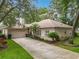Beautiful home with a manicured lawn, mature trees, and a charming front entrance at 1701 Lucky Pennie Way, Apopka, FL 32712
