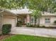 Charming single story home with a well-manicured lawn, neutral paint, mature trees, and an American flag at 1701 Lucky Pennie Way, Apopka, FL 32712