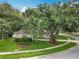 Charming home with mature trees, green lawn, and landscaped flowerbeds, offering great curb appeal at 1701 Lucky Pennie Way, Apopka, FL 32712