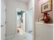 Hallway leading to the bathroom with tile flooring and lovely decor at 1701 Lucky Pennie Way, Apopka, FL 32712