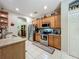 Functional kitchen featuring stainless steel appliances and wooden cabinets for plenty of storage at 1701 Lucky Pennie Way, Apopka, FL 32712