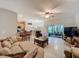 Spacious living room with tile flooring, comfortable seating, and a sliding glass door at 1701 Lucky Pennie Way, Apopka, FL 32712