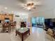 Open concept living room featuring a wet bar, lots of tile flooring and sliding glass doors to the patio at 1701 Lucky Pennie Way, Apopka, FL 32712