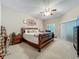 Comfortable main bedroom with a ceiling fan and carpeted floor, featuring soft, natural light at 1701 Lucky Pennie Way, Apopka, FL 32712