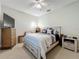 Tranquil bedroom features neutral walls, a ceiling fan, and stylish furnishings at 1701 Lucky Pennie Way, Apopka, FL 32712