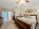 Comfortable main bedroom featuring neutral carpeting and access to the en suite bathroom at 1701 Lucky Pennie Way, Apopka, FL 32712