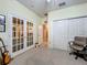 Office space featuring french doors, carpeted floors, and a ceiling fan providing great ventilation at 1701 Lucky Pennie Way, Apopka, FL 32712
