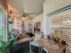 Inviting screened porch with cozy seating, decorative accents, and serene backyard views at 1701 Lucky Pennie Way, Apopka, FL 32712
