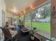 Large screened porch with outdoor dining and lounging areas overlooking a lush, fenced backyard at 1701 Lucky Pennie Way, Apopka, FL 32712