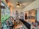 Relaxing screened porch with comfortable furniture, a ceiling fan, and seamless indoor-outdoor living at 1701 Lucky Pennie Way, Apopka, FL 32712