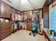 Spacious walk-in closet featuring custom built-in shelving and a small window to let in natural light at 1701 Lucky Pennie Way, Apopka, FL 32712