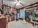 Spacious walk-in closet featuring custom built-in shelving and a small window to let in natural light at 1701 Lucky Pennie Way, Apopka, FL 32712