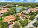 Aerial view of home in an established neighborhood with mature trees, landscaping, and a pond at 172 Verde Way, Debary, FL 32713