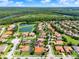 An aerial view of the community with homes with pools, landscaping, and lake access at 172 Verde Way, Debary, FL 32713