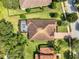 Aerial view of home with a screened-in pool and a tile roof, surrounded by mature trees at 172 Verde Way, Debary, FL 32713