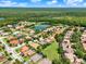 A beautiful aerial view shows the real estate neighborhood with manicured lawn and a pond at 172 Verde Way, Debary, FL 32713