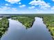 Aerial view shows the community's access to the river with trees and lush landscaping at 172 Verde Way, Debary, FL 32713