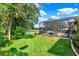 Expansive backyard with a screened patio, hot tub, and picturesque lake views at 172 Verde Way, Debary, FL 32713