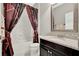 Bathroom vanity with granite countertop and tiled shower with dark curtain at 172 Verde Way, Debary, FL 32713