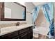 Bathroom with dark cabinets, granite countertop, and shower-tub combination at 172 Verde Way, Debary, FL 32713