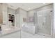 Bright bathroom featuring tiled shower, soaking tub, and granite vanity at 172 Verde Way, Debary, FL 32713
