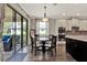 Charming dining area with wood-look tile, a modern light fixture, and access to the outdoor patio at 172 Verde Way, Debary, FL 32713