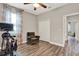 Exercise room with Peloton bike, hardwood floors, and a cozy sitting chair at 172 Verde Way, Debary, FL 32713