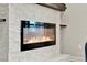Modern fireplace featuring a white brick surround and wood beam at 172 Verde Way, Debary, FL 32713