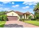 Beautifully landscaped front yard leads to this one-story home with brick driveway and tiled roof at 172 Verde Way, Debary, FL 32713