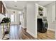 Beautiful entranceway with laundry room featuring black appliances and wood-look tile at 172 Verde Way, Debary, FL 32713