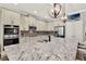 Kitchen area with stainless steel appliances, center island with granite counters, and pendant lighting at 172 Verde Way, Debary, FL 32713