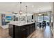 Open concept kitchen with large island, granite countertops, and modern stainless appliances at 172 Verde Way, Debary, FL 32713