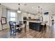 Open kitchen featuring an island, granite countertops, stainless appliances, and wooden flooring at 172 Verde Way, Debary, FL 32713