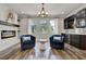 Elegant living room featuring a fireplace, stylish seating, and a bar with a wine fridge at 172 Verde Way, Debary, FL 32713