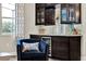 Living room detail featuring the bar, wine fridge and elegant decor at 172 Verde Way, Debary, FL 32713