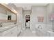 Spacious bathroom featuring double vanity, soaking tub, and walk-in closet at 172 Verde Way, Debary, FL 32713