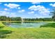 Scenic view of a tranquil pond surrounded by lush greenery in a serene neighborhood at 172 Verde Way, Debary, FL 32713