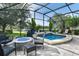 Spacious screened patio with a hot tub, fire pit, and outdoor seating overlooking the water at 172 Verde Way, Debary, FL 32713