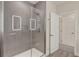 Modern bathroom showcasing a glass-enclosed shower, illuminated mirror, and neutral tones at 17441 Hidden Forest Dr, Clermont, FL 34714