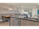 Open-concept living and dining area with modern kitchen, sleek countertops, and access to the outdoor pool at 17441 Hidden Forest Dr, Clermont, FL 34714