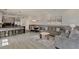 Spacious living room with dining area, stylish seating, and modern kitchen featuring barstool seating at 17441 Hidden Forest Dr, Clermont, FL 34714