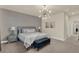 Comfortable main bedroom with stylish furnishings, decorative wall paneling, and modern lighting fixture at 17441 Hidden Forest Dr, Clermont, FL 34714